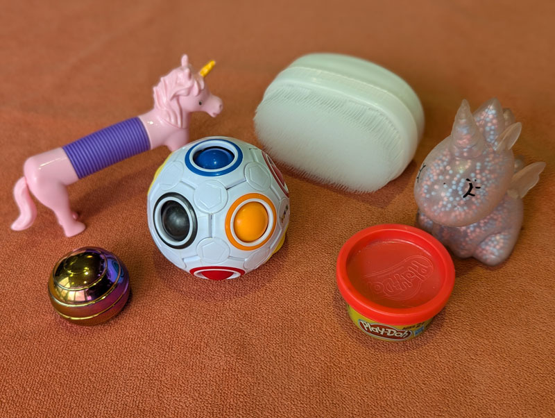 a flat lay of a variety of sensory tools and fidget toys