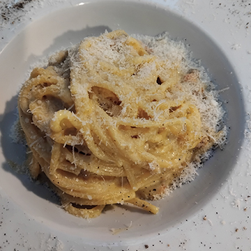 Spaghetti carbonara with shaved pecorino and freshly ground black pepper
