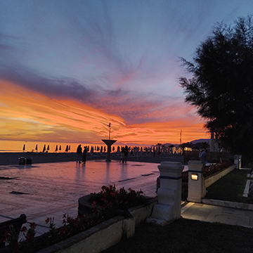 Stunning sunset on the Tuscan coast with vivid hues of oranges, pinks and purples