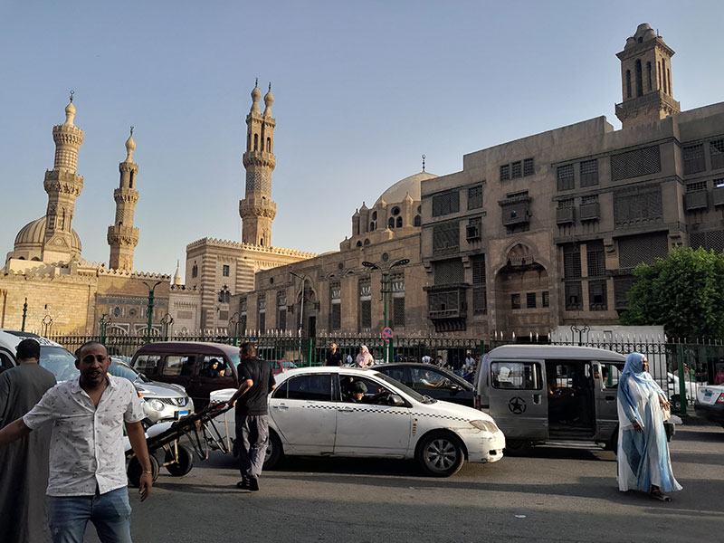 People and cars in front of a mosque near Khan el Khalili, Cairo