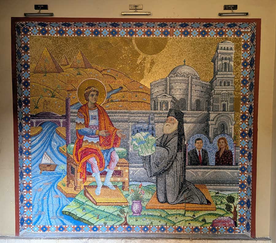 Intricate mosaic artwork inside the Church of St. George blending ancient iconography with modern figures, with pyramids and the Nile in the background.